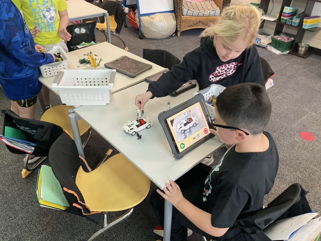 elementary students using technology to make a movie