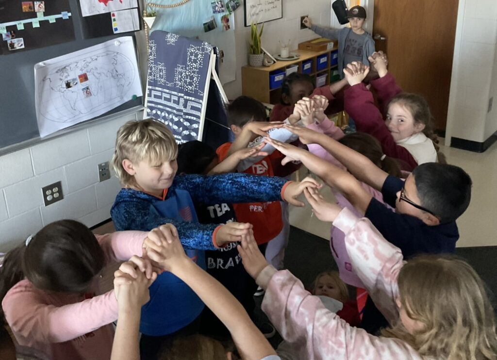 elementary students forming a bridge