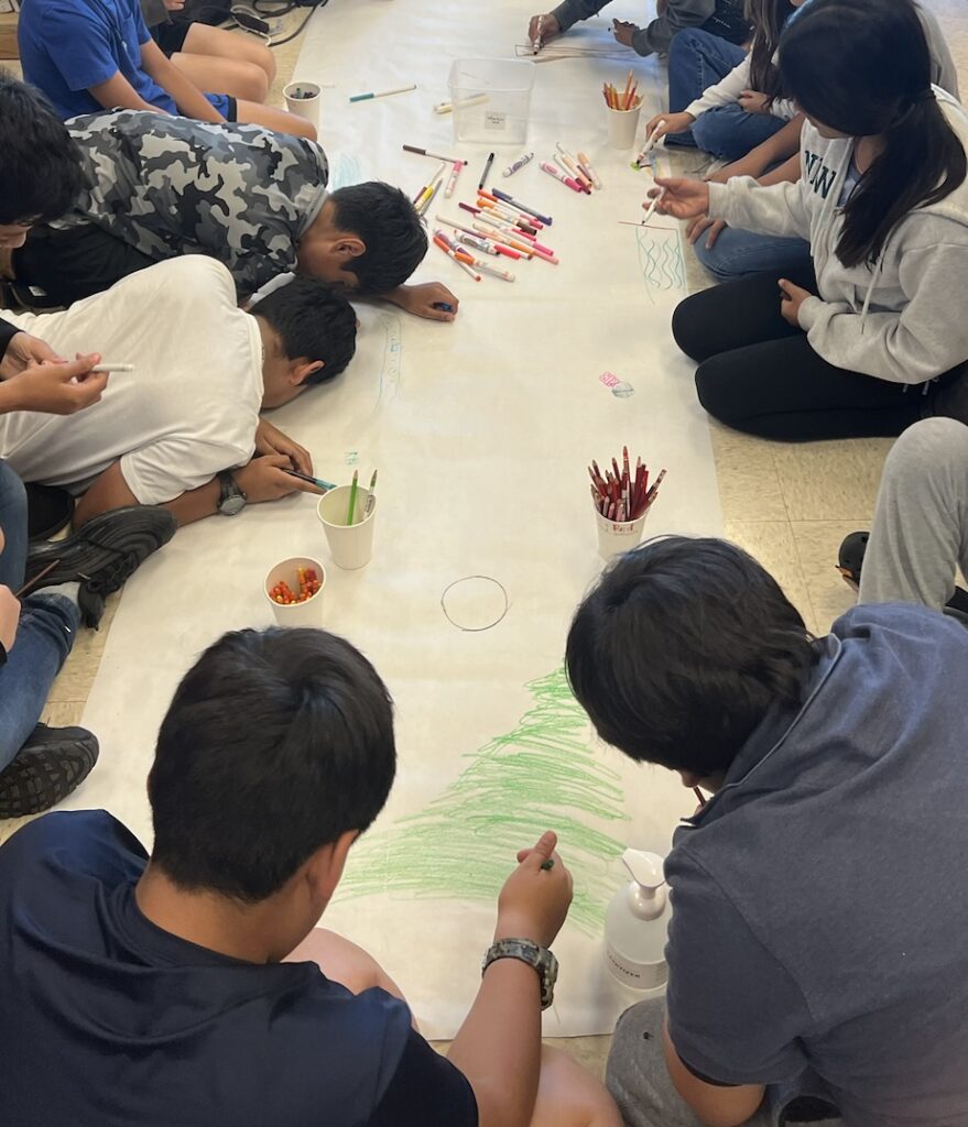 students working on a long roll of paper