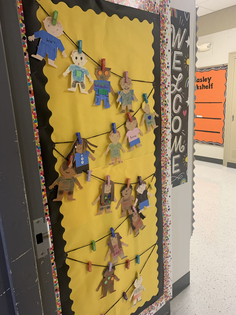 puppets of students strung across a classroom door