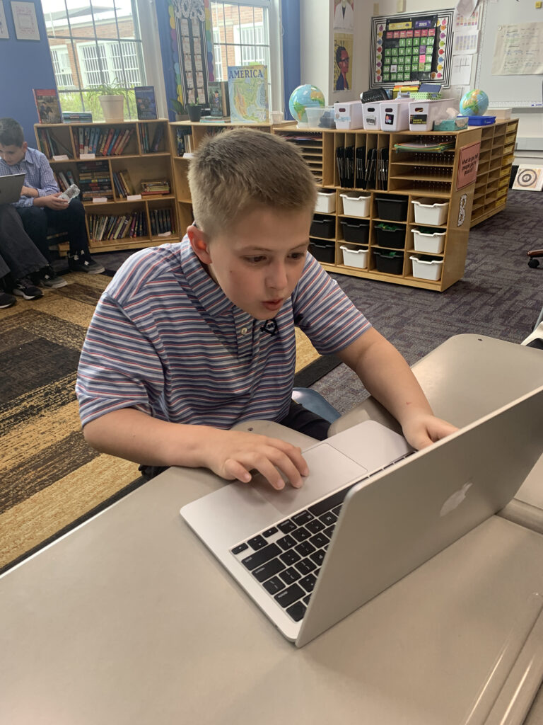 boy using laptop computer
