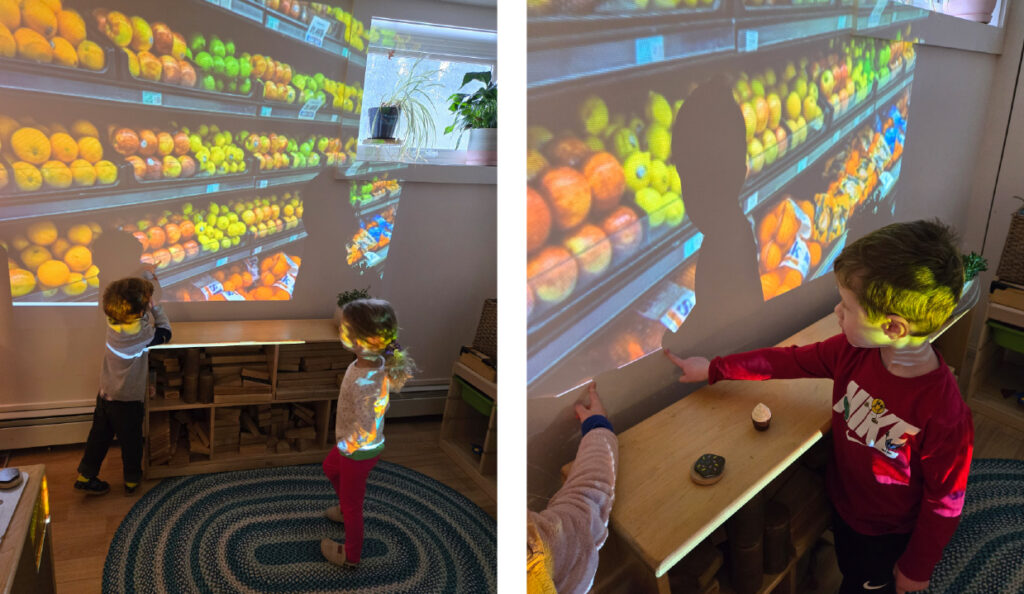 elementary students pointing to details of a grocery store on a classroom projection screen