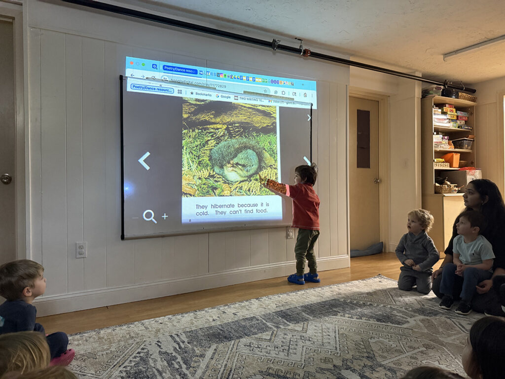elementary students studing about hibernation on projection screen