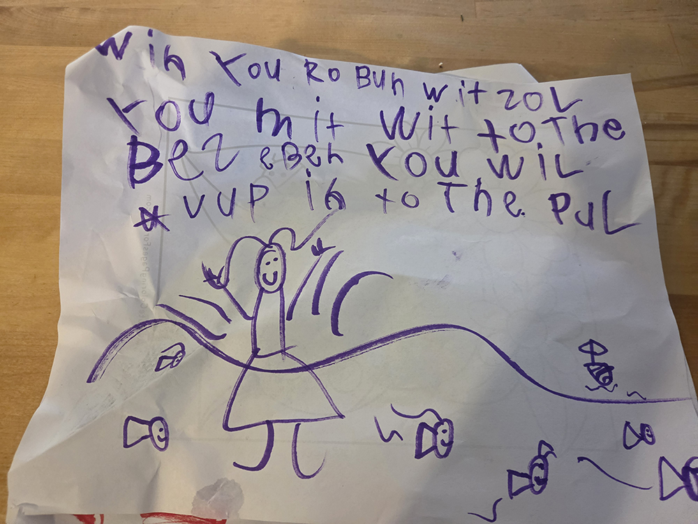 a sheet of paper with artwork and writing done by a six-year-old